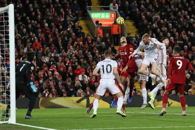 Virgil van Dijk clears under pressure from Oli McBurnie at Anfield. Picture: James Wilson/Sportimage