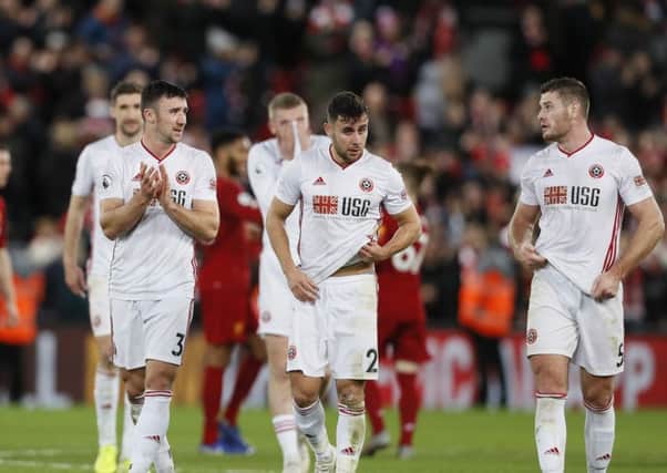Sheffield United's Enda Stevens, George Baldock and Jack O'Connell walk over to applaud the visiting fans at Anfield. Picture: James Wilson/Sportimage