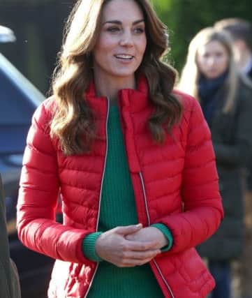 Catherine, Duchess of Cambridge, wearing this neat red padded jacket layered over a soft green ribbed sweater. Street-wise yet classic, cosy without inconvenient bulkiness - and who said "red and green should never be seen"? This proves it's nonsense. Picture: Jonathan Brady/PA Wire