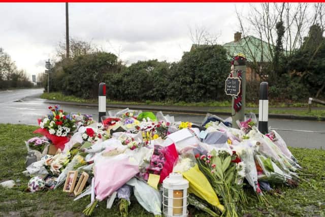 Floral tributes that have been left at the scene in Stanwell, near London's Heathrow Airport, of a fatal crash on New Year's Eve in which three British Airways cabin crew died. PA Photo.