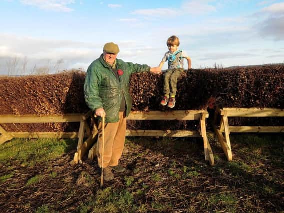 Mick Easterby pictured with his grandson Albert aged 5 by the fences ready for the new season.