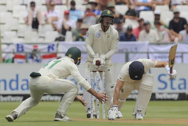 Almost on their knees: Joe Denly, right, has to get down low to play a shot as South Africas wicketkeeper Quinton de Kock and Pieter Malan watch on. (AP Photo/Halden Krog)