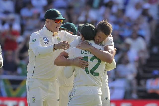 South African bowler Dwaine Pretorius celebrates the wicket of England batsman Jos Buttle during day one of the second cricket test between South Africa and England at the Newlands Cricket Stadium. (AP Photo/Halden Krog)