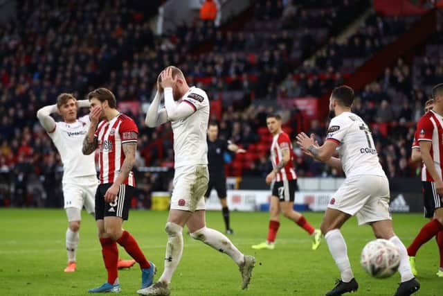 Fylde Alex Whitmore, centre, reacts after a missed chance against Sheffield United at Bramall Lane (Picture: Tim Goode/PA Wire).