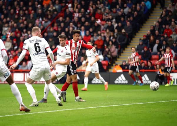 Sheffield United's Callum Robinson, right, scores his side's first goal in their 2-1 FA Cup third round defeat of National League Fylde at Bramall Lane (Picture: Tim Goode/PA Wire).