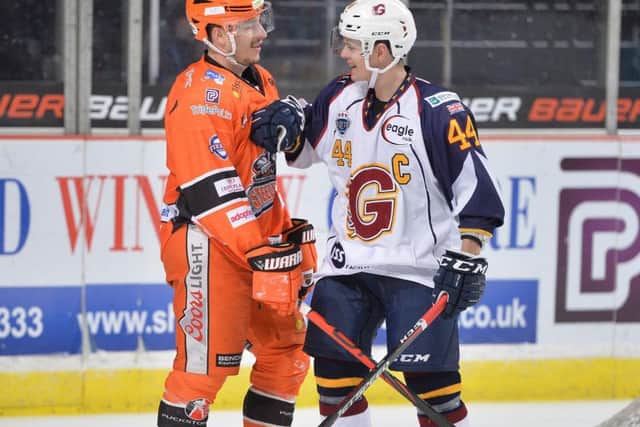 Tanner Eberle shares a few words with Guildford's Jesse Craige, the Steelers' forward scoring twice in the 6-2 win over the Flames. Picture courtesy of Dean Woolley.