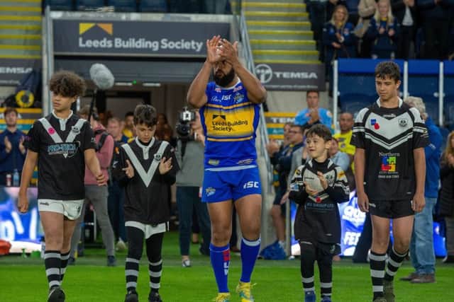 Jamie Jones-Buchanan and his sons as he starts his last game for 
Leeds Rhinos v Warrington Wolves last September.
(Picture: Bruce Rollinson)