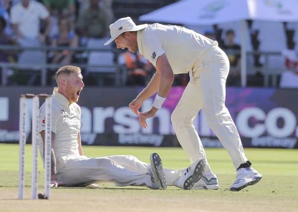 Ben Stokes, left, and Stuart Broad celebrate the wicket of Anrich Nortje during day five of the second cricket test between South Africa and England (AP Photo/Halden Krog)