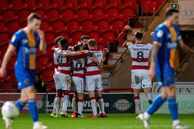 Doncaster Rovers players celebrate Tom Anderson's goal