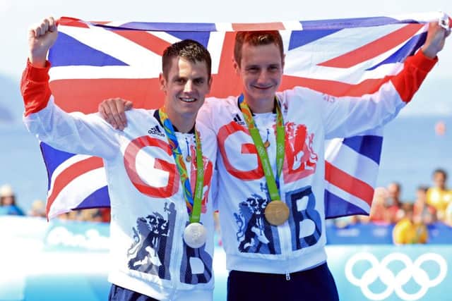 2016 Olympics gold medal winner Alistair Brownlee, right, celebrates with silver medal-winning brother Jonny in Rio. Picture: Mike Egerton/PA.