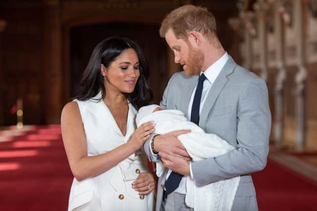 The Duke and Duchess of Sussex pose for photos with their new-born son Archie.