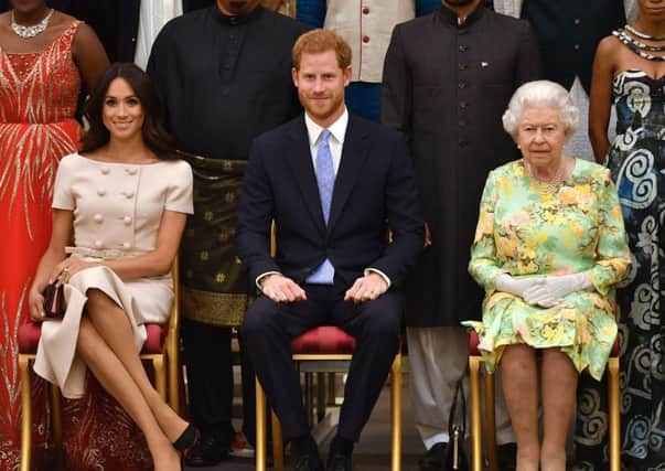 The Queen with the Duke and Duchess of Sussex at a Buckingham Palace reception in 2018.
