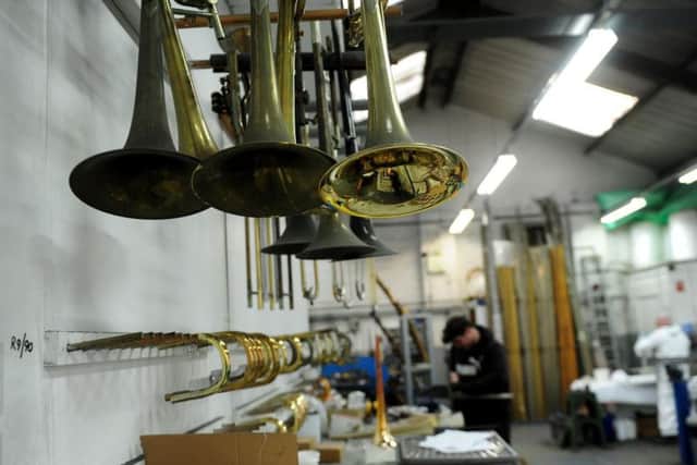 Craftsmen working on brass instruments at Mick Raths workshop at Honley, Huddersfield.