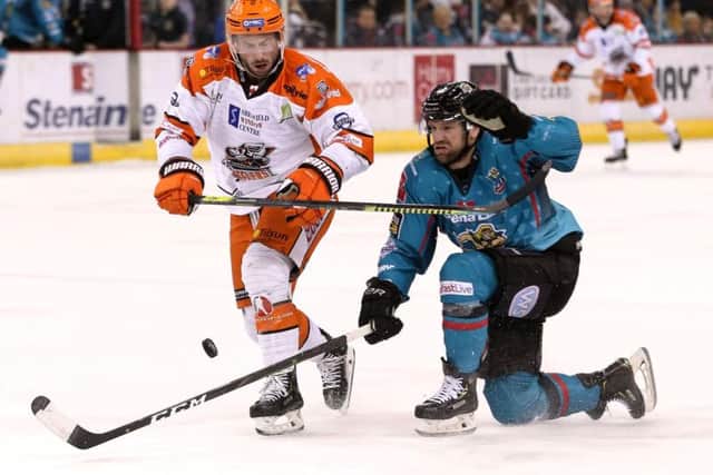 BATTLE LINES: Sheffield Steelers' Aaron Brocklehurst battles for possession in Friday night's clash at Belfast Giants. Picture: William Cherry/EIHL.
