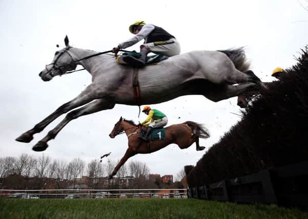 Joke Dancer and Danny Cook, rear, on their way to success at Warwick