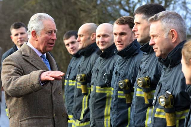 The Prince of Wales with some of the firefighters who responded to the recent floods in Fishlake.