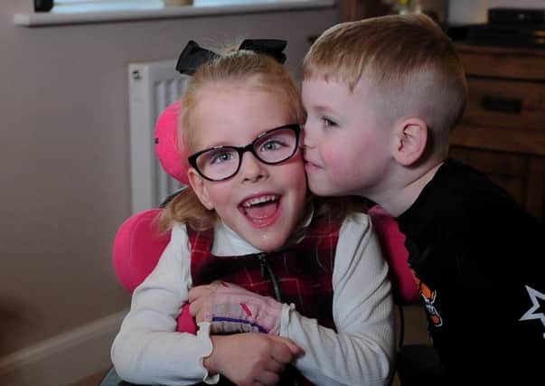 Little Esmae Robinson who suffers from Cerebral Palsy pictured with her  brother Riley who has autism at their home at Thorpe Willoughby, Selby Picture by Simon Hulme