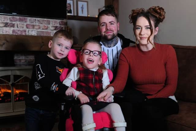 Esmae  pictured with her Mum and dad Lora and Josh and brother Riley. Esmae contracted meningitis and septacaemia when shew as  a baby which left her with cebreal palsy.Picture by Simon Hulme