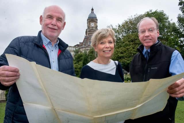 Councillor Eric Firth, (Lab, Dewsbury East) Marilyn Shaw, of Dewsbury Forward and Paul Ellis, President of the Dewsbury Chamber of Trade, look at plans for the mining monument. Credit: Mike Bickerdike