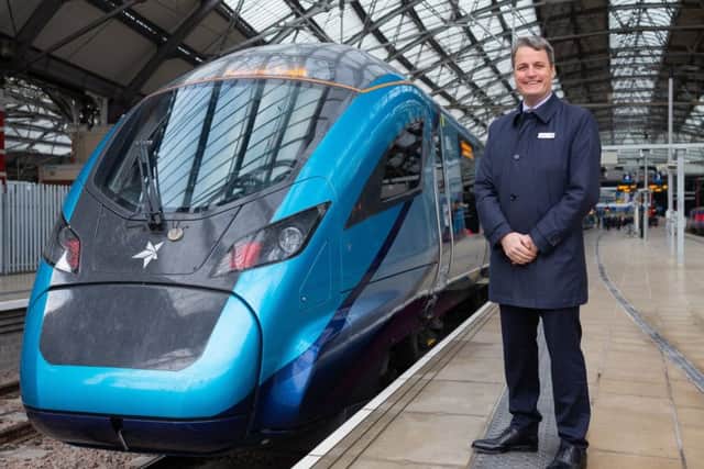 TransPennine Express managing director Leo Goodwin poses alongside one of the new £500m Nova trains which were unveiled today at Liverpool Lime Street.