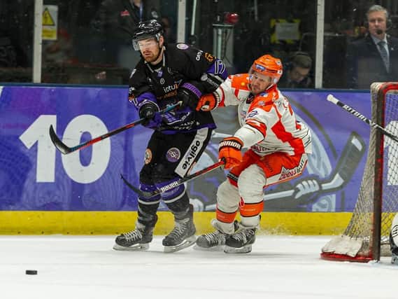 Jonathan Phillips battles for possession at the intu Braehead Arena on Wednesday night. Picture courtesy of Al Goold/EIHL.
