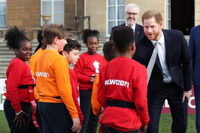 The Duke of Sussex meets children in the Buckingham Palace gardens, London, as he hosts the Rugby League World Cup draws.
