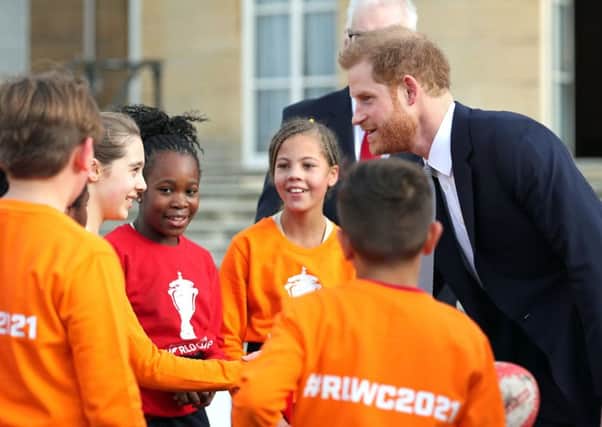 The Duke of Sussex chats with rugby league fans in the Buckingham Palace gardens. Picture: Yui Mok/PA