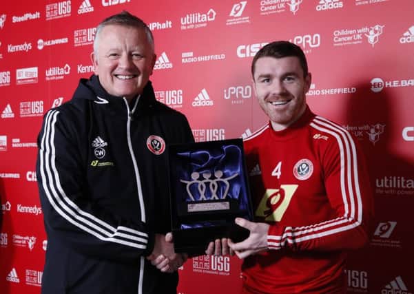 Chris Wilder manager of Sheffield United presents John Fleck of with a memento to acknowledge his 150th appearance for the club (Picture: Simon Bellis/Sportimage)
