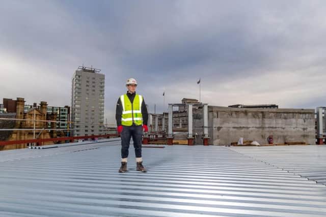Eddy Bryan, graduate engineer for Sir Robert McAlpine looking at the construction progress to date at the Majestic