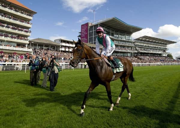 Tom Queally celebrates Frankel's win in the 2012 Juddmone International at York, arguably the world-beating horse's finest hour.
