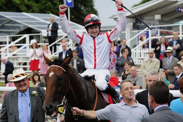 Tom Queally celebrates his Ebor win on Tiger Cliff.