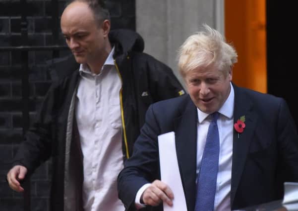 Boris Johnson leaves 10 Downing Street with his policy aide Dominic Cummings.