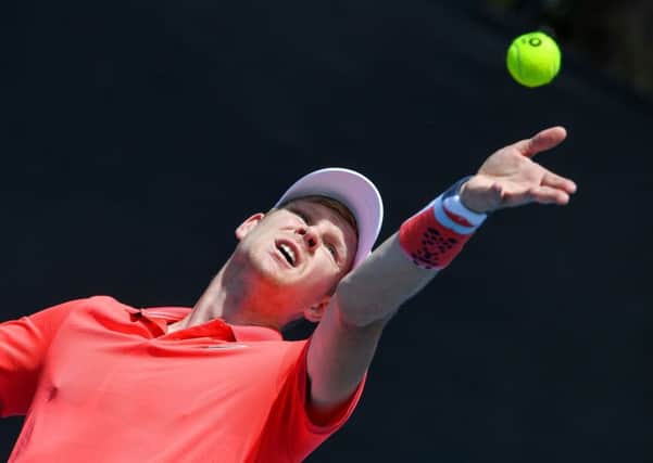DOWN AND OUT: Kyle Edmund serves against Serbia's Dusan Lajovic on day two of the Australian Open in Melbourne. Picture: Greg Wood/AFPGetty Images