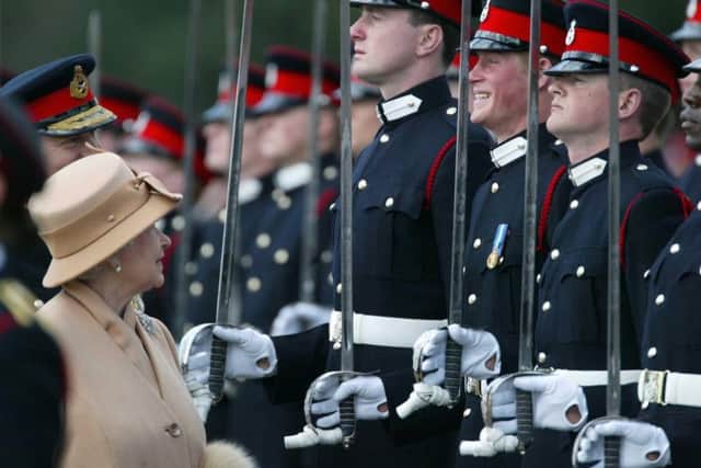Prince Harry smiles broadly as his grandmother Queen Elizabeth II reviews him and other officers during The Sovereign's Parade at the Royal Military Academy at Sandhurst in Surrey to mark the completion of their training. The Duke of Sussex fought in Afghanistan on the frontline, but is now severing his official ties to the military as he quits royal life completely. Photo credit: James Vellacott/PA Wire