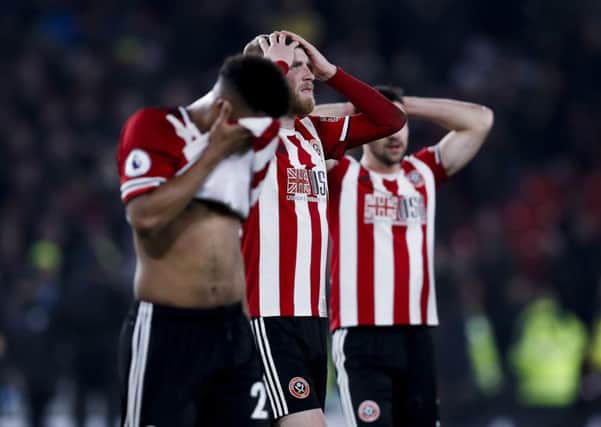 Lys Mousset, Oliver McBurnie and Enda Stevens of Sheffield United look dejected after losing during the Premier League match at Bramall Lane.   Picture: James Wilson/Sportimage