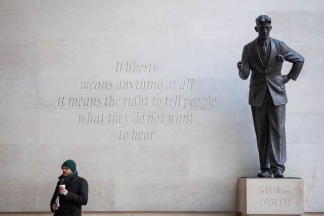 A man stands next to George Orwell's statue outside BBC Broadcasting House, at Portland Place, London, following BBC Director General Tony Hall's announcement that he intends to step down in the summer.