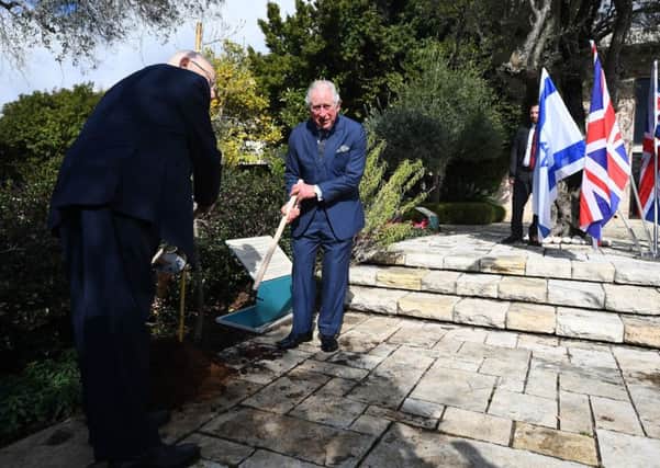The Prince of Wales plants a tree after a meeting with President Reuven Rivlin (left) at his official residence in Jerusalem on the first day of his visit to Israel and the occupied Palestinian territories.