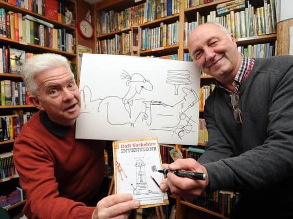 Ian and cartoonist Tony Husband, signing copies of their book Daft Yorkshire Inventions at Rickaro Books in 2014.