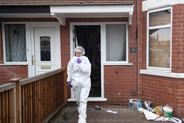 Forensics officers at the scene of a fire at a house on Wensley Avenue, Hull, where two people have died, including an eight-year-old. Danny Lawson/PA Wire