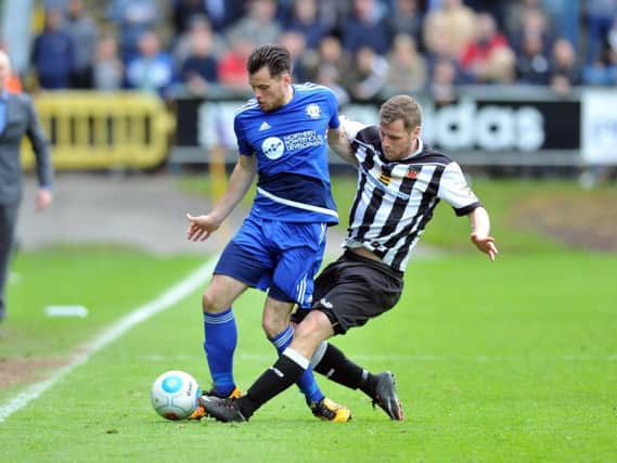 Jordan Sinnott, pictured in blue, in action for FC Halifax Town. PIC: Tony Johnson