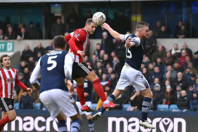 Billy Sharp of Sheffield United is challenged by Alex Pearce of Millwall. Picture: Robin Parker/Sportimage