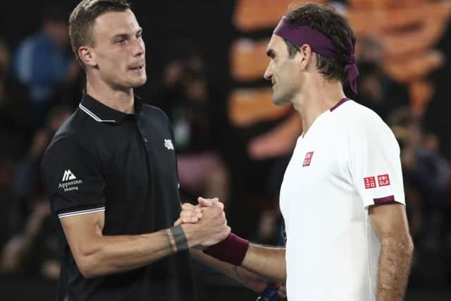 Switzerland's Roger Federer, right, is congratulated by Hungary's Marton Fucsovics. Picture: AP/Dita Alangkara