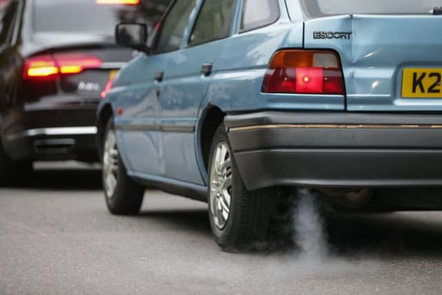 A car emits fumes from its exhaust as it waits in traffic in central London.  Photo: Daniel Leal-Olivas/AFP/Getty Images)