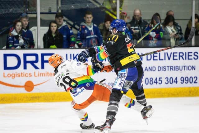 COLLISION COURSE: Sheffield Steelers' Lucas Sandstrom, left, takes a mid-ice hit in last night's overtime win at Coventry Blaze. Picture courtesy of Scott Wiggins/EIHL.