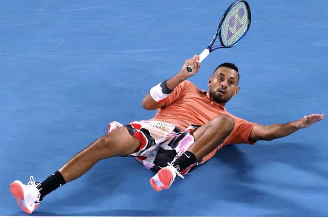 DOWN AND OUT: Nick Kyrgios falls as he attempts to return a shot to Rafael Nadal in Melbourne. Picture: AP/Andy Wong