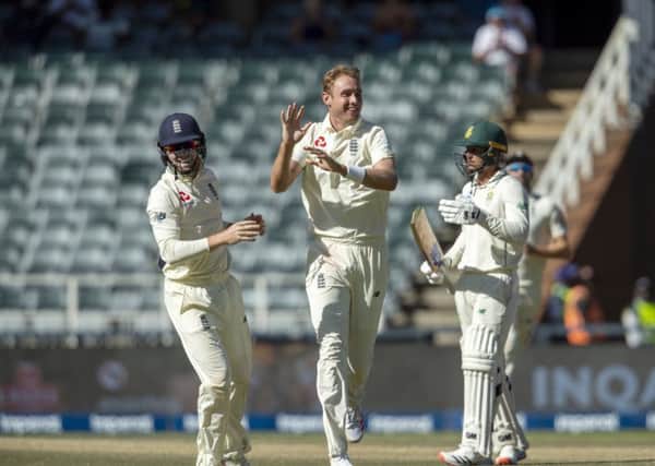 England's bowler Stuart Broad, centre, celebrates with team-mate Ollie Pope, left, after dismissing South Africa's batsman Dwaine Pretorius.