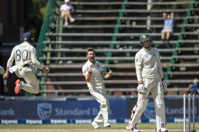 England's bowler Mark Wood, centre, reacts after dismissing South Africa's batsman Rassie van der Dussen, right, for 98.