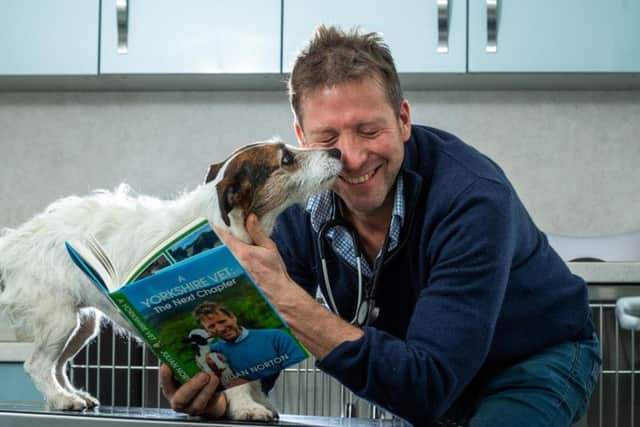 Yorkshire vet Julian Norton with his new book and Emmy the Jack Russell.