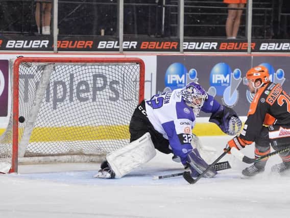 Lucas Sandtrom, right, squeezes the puck past Glasgow goalie Patrick Killeen in Wednesday's 4-0 win for Sheffield Steelers. Picture: Dean Woolley.
