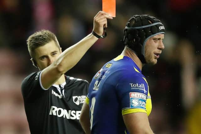 welcome back: Warrington Wolves Chris Hill is sent off by referee Chris Kendall after just 22 minutes for a tackle on Wigan Warriors Sam Powell during the opening night of Super League at the DW Stadium. Report: Page 22. Picture: Martin Rickett/PA